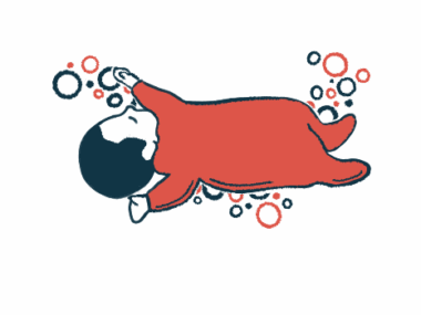 An infant in a red sleeper is seen napping.