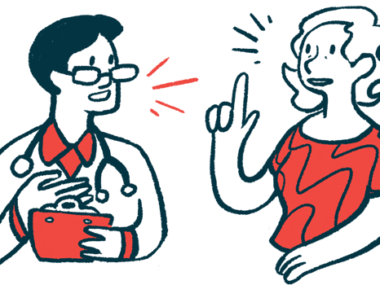 A woman talks with a medical professional holding a clipboard.