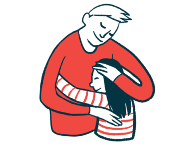 An adult caresses the head of a child as the pair share a hug.