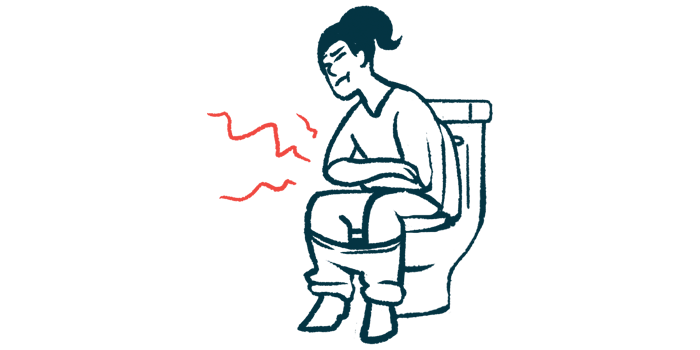 Girl is sitting on a toilet holding her stomach in pain.