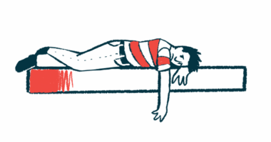 A person who looks upset and dejected lays on a mattress.